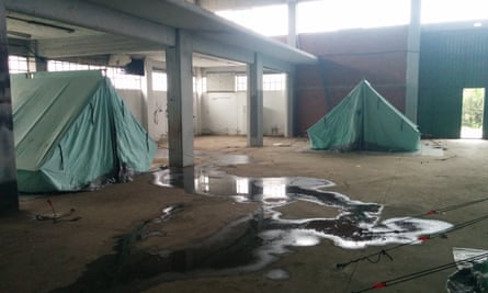 Tents are pitched on filthy concrete floors