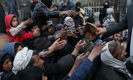 People reach out to receive bread in Kabul