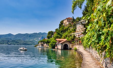 Cobblestone path bordering Lake Orta that leads hikers to the village of Orta San Giulio on Lake Orta, Italy.