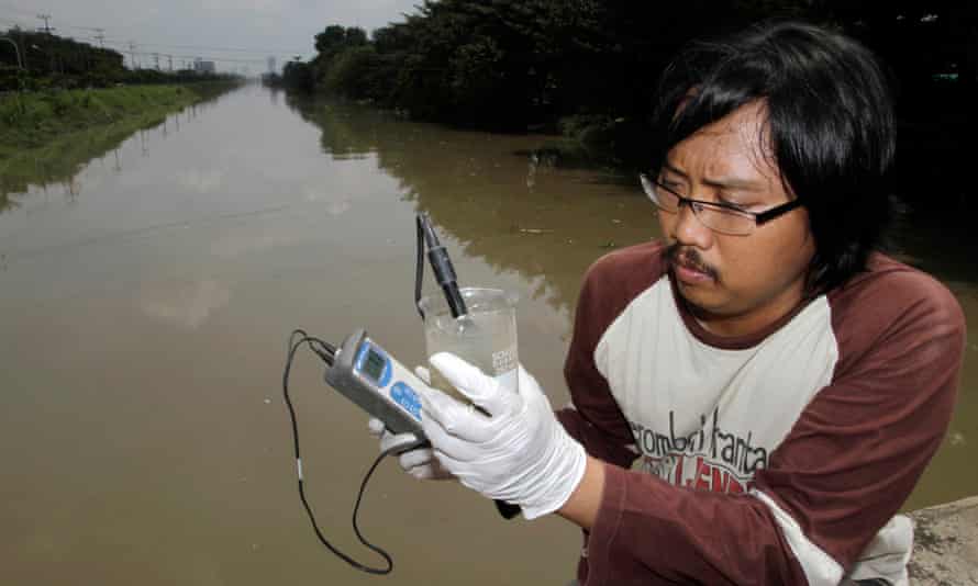 Prigi Arisandi examines polluted river water