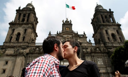 A couple kiss each other in front of the cathedral during a march in support of gay marriage, sexual and gender diversity in Mexico City on 11 September 2016.