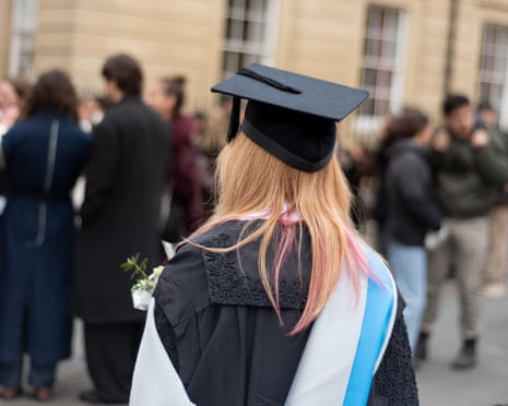 Rear view of a graduate in cap and gown at a graduation ceremony