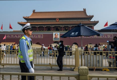 Police officers stand guard outside Tiananmen Gate.