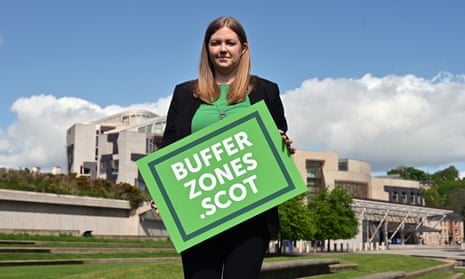 Scottish Green party MSP Gillian Mackay holding a placard stating 'bufferzones.scot'