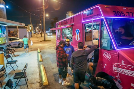 Patrons stand outside El Bori, a popular food truck serving Puerto Rican cuisine, in Miami.