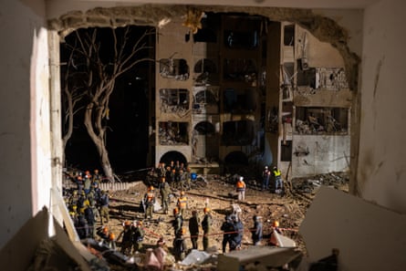 Emergency workers gather at the site of an Iranian missile strike