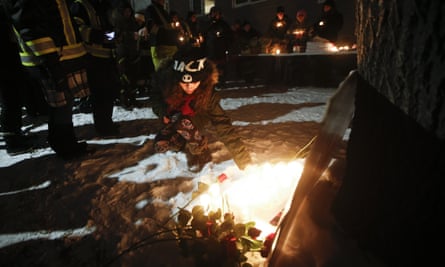 Harris places a candle at a vigil in Manitoba, Winnipeg, on 1 December.