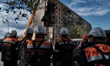 Emergency services work at a scene after a missile hit an apartment building in Kryvyi Rih, Ukraine, Monday, 31 July 2023.