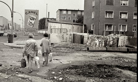 Berliners walk among the ruins of the Wall.