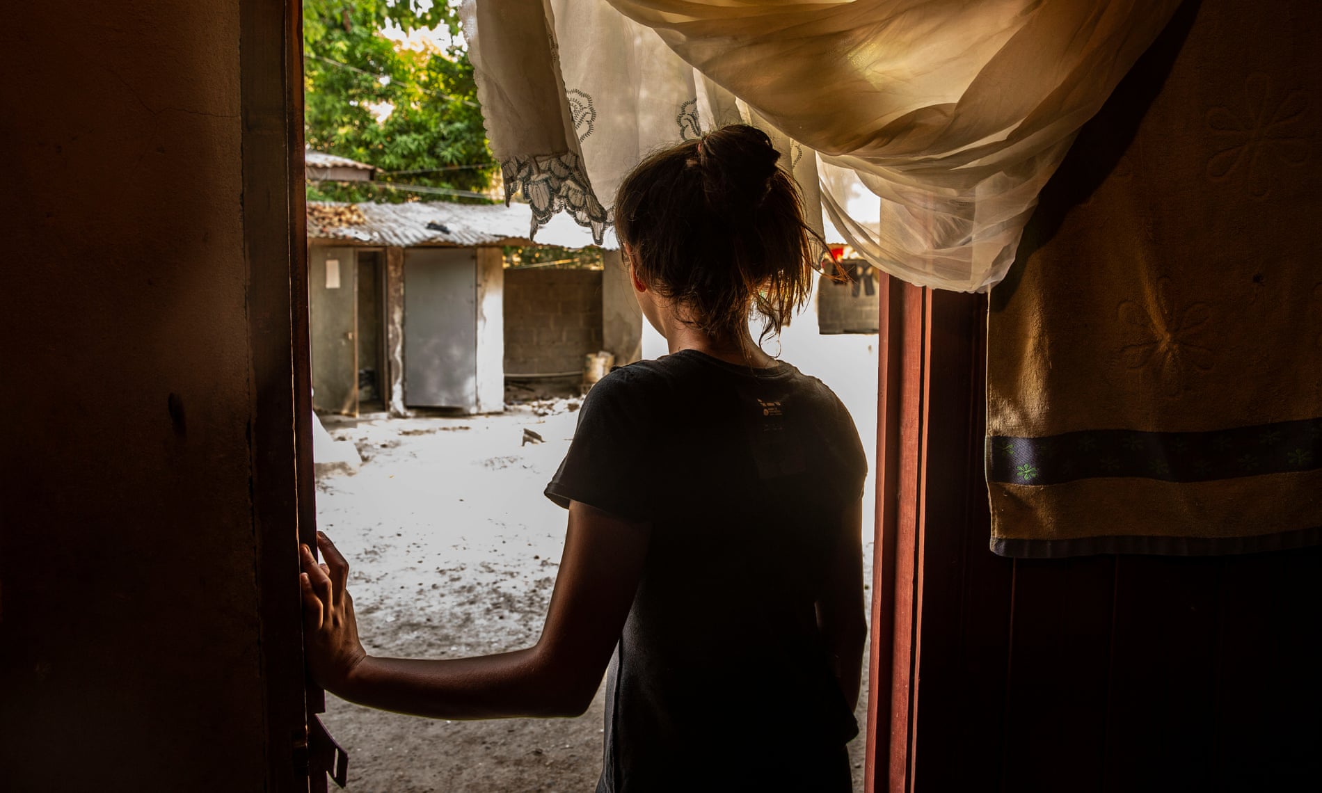 Carla at the front door of her house in San Pedro Sula, Honduras. She had two abortions in the last year and half. 