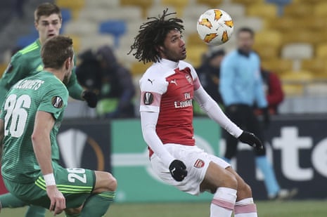 Arsenal’s Mohamed Elneny, right, controls the ball as Vorskla’s Yuri Kolomoets looks on.