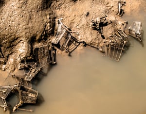 Unwanted objects, mainly shopping trolleys, in a river estuary in Kent, revealed at low tide