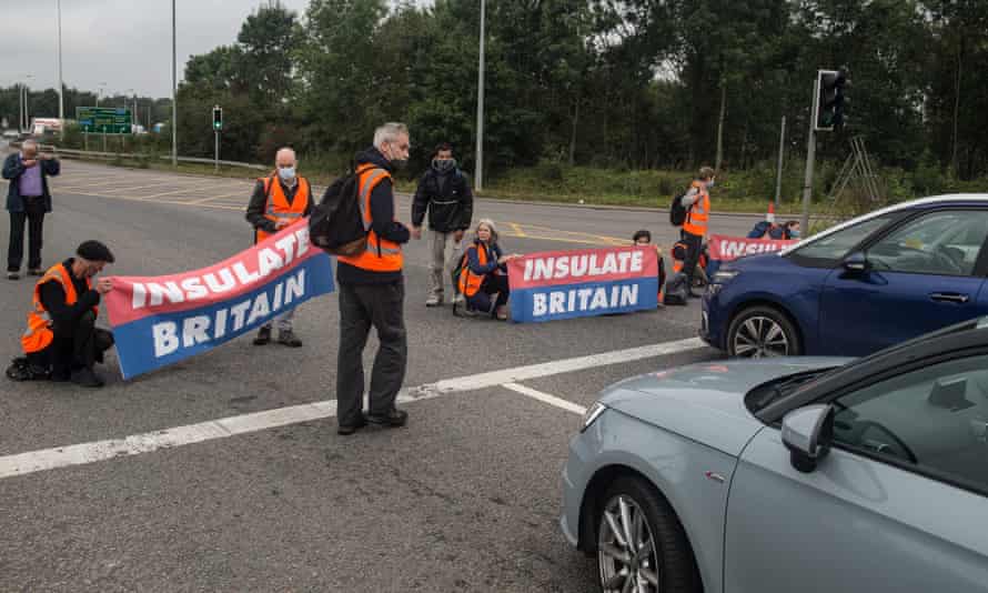 Protesters from the Insulate Britain pressure group block a roundabout near Stansted Airport.