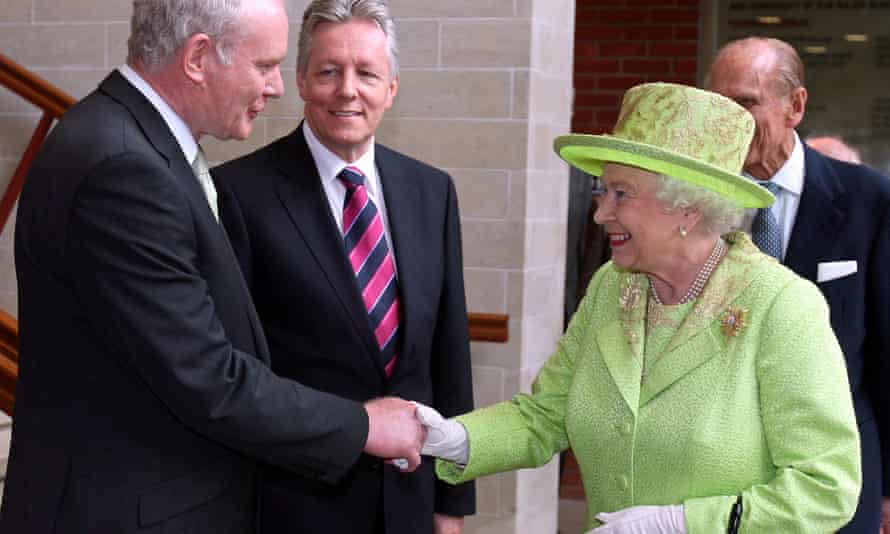 Martin McGuinness shaking hands with the Queen, with first minister Peter Robinson, centre, in Belfast in 2012