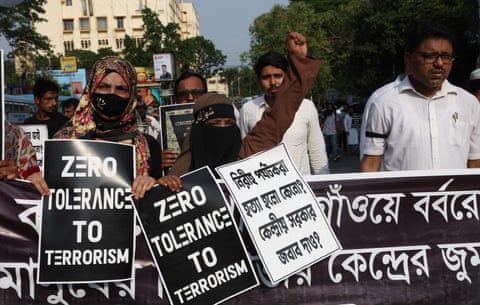 People hold placards at a protest