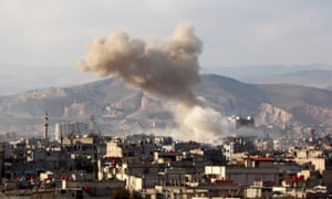 Smoke rises after Syrian regime aircraft carried out airstrikes on a town in the eastern Ghouta region near Damascus on 5 March.