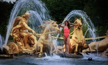 The swimmer Béryl Gastaldello stands in the Fountain of Apollo at the Palace of Versailles