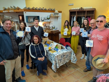 Participants hold their finished tiles.