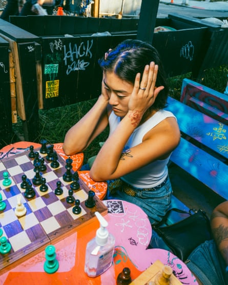 A chess player at Purgatory Bar plans their next move during the Queers Gambit event.