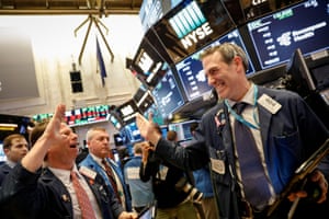 Traders celebrate after the closing bell on the floor of the NYSE in New York