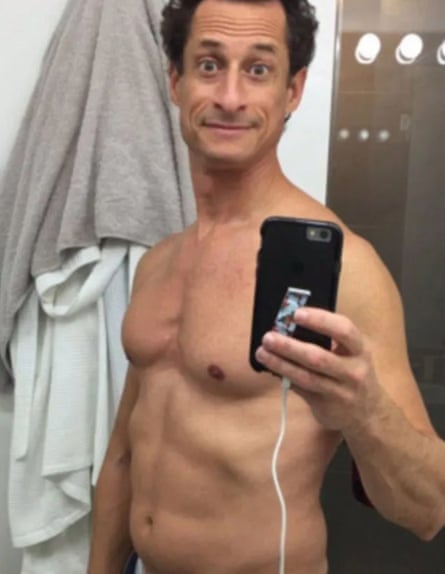 Anthony Weiner, naked from the waist up, holding his phone in front of him to take a sexting photo