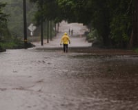 US Hawaii Extreme Weather NoloFire Captain Lui Sales of the Hawaii Fire Department looks for residents to help as rainwater from nearby Hurricane Nolo flood a section of Mamalahoa highway Saturday, Sept. 26, 2026, near Naalehu, Hawaii. (AP Photo/Gregory Bull)
