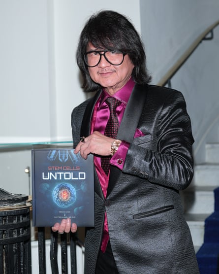 Man holds book with Stem Cells Untold on cover