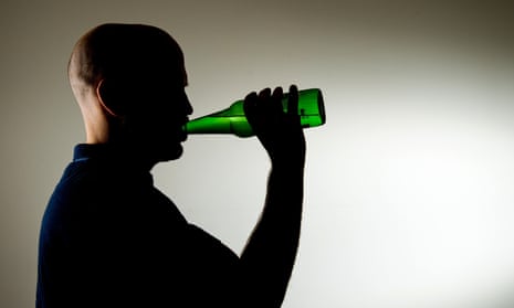 Middle aged man in silhouette drinking from a bottle