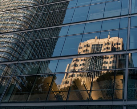 Skyscrapers reflected on the facade of a glass building