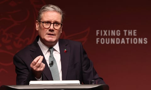 Keir Starmer standing in front of the words, 'Fixing the foundations.'