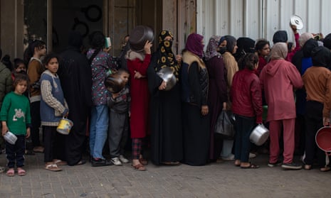 نازحون فلسطينيون يصطفون للحصول على طعام مجاني توزعه مجموعة شبابية فلسطينية في مخيم خان يونس للاجئين