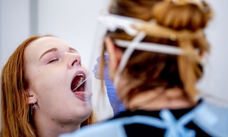 a woman has her throat swabbed