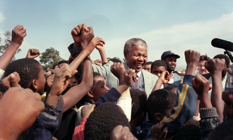 Nelson Mandela is surrounded by young supporters after addressing residents at Phola Park, a squatter settlement east of Johannesburg, 31 May 1992.
