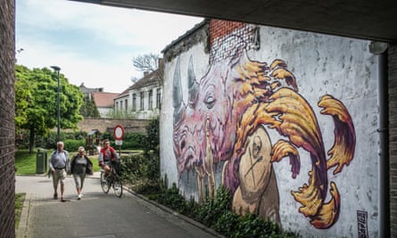 Written on the wall: pedestrians, bikes and street art all give to give Ghent a modern edge.