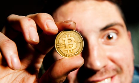Amir Taaki, Bitcoin project manager, holding a Bitcoin in 2013.