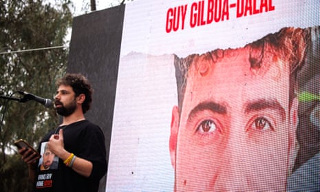 Gal Dalal speaking  in front of a picture of his brother, Guy, during a press conference at the Nova music festival site.