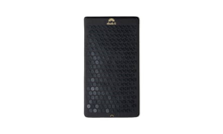A black Shakti premium acupressure mat featuring little black spikes