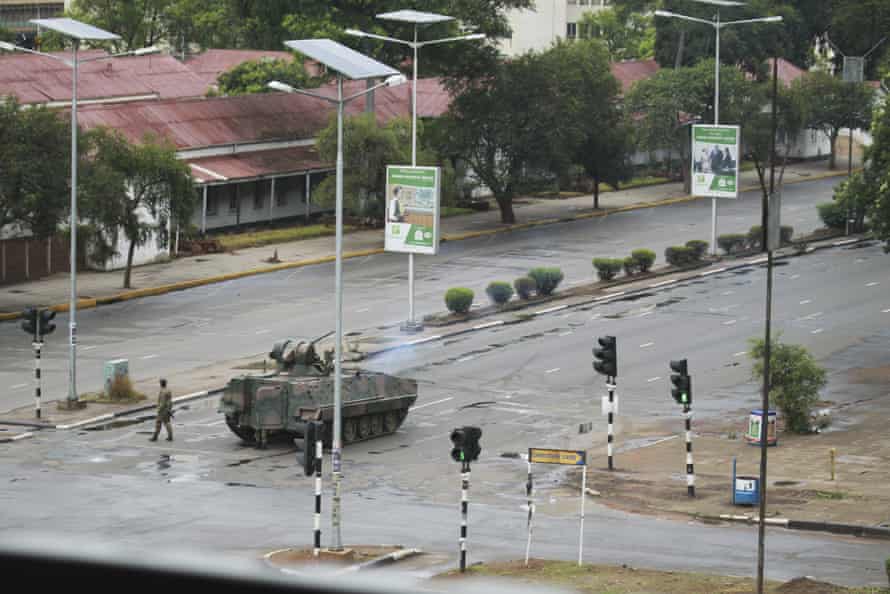 A military tank is seen with armed soldiers on the road leading to President Robert Mugabe’s office in Harare, Wednesday, Nov. 15, 2017. Overnight, at least three explosions were heard in the capital, Harare, and military vehicles were seen in the streets. On Monday, the army commander had threatened to “step in” to calm political tensions over the 93-year-old Mugabe’s possible successor. (AP Photo/Tsvangirayi Mukwazhi)