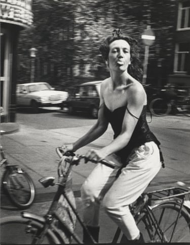 Woman cycling, Amsterdam 1983 sticking her tongue out at the photographer