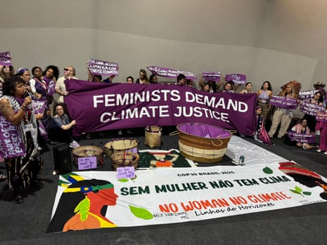 A group of women hold up a banner saying "feminists demand climate justice" at the Cop30 climate summit in Belem, Brazil.