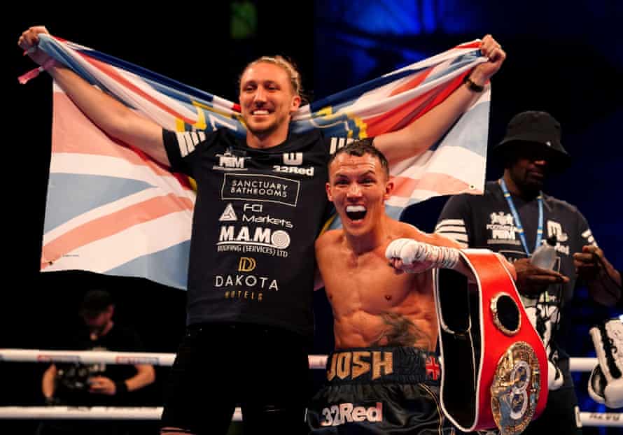 Josh Warrington celebrates in the ring with Leeds United’s Luke Ayling.