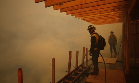 Firefighters monitor the advance of the Palisades Fire in Mandeville Canyon on Saturday, Jan. 11, 2025, in Los Angeles. (AP Photo/Eric Thayer)