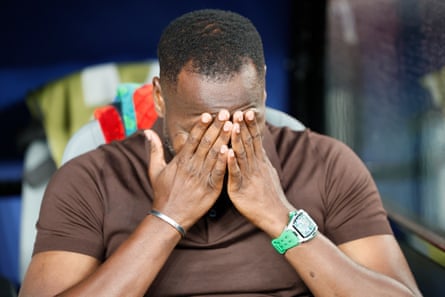 Pape Thiaw puts his head in his hands.