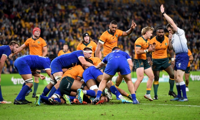 Michael Hooper (centre) of the Wallabies pushes over to score.
