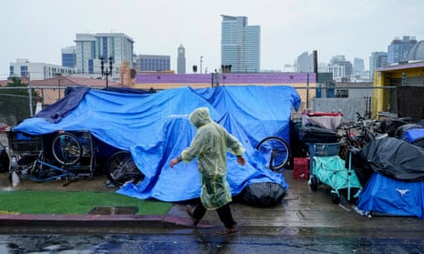 Homeless people use plastic tarps to shield themselves from rain in downtown San Diego.