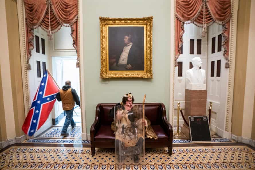 Lawmakers barricaded themselves inside the chambers, wearing tear gas masks, while rioters vandalized the building.