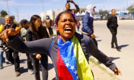 A woman reacts as migrants protest against the Mexican government immigration policy during the visit of President Andrés Manuel López Obrador in Ciudad Juárez.