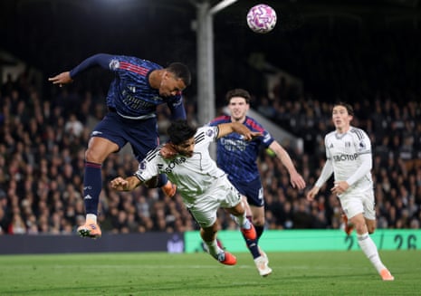 Gabriel of Arsenal wins a header against Raul Jimenez of Fulham.