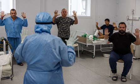 Patients recovering from coronavirus perform breathing exercises with a physiotherapist.
