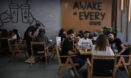 Young people chat at Grinders coffee shop in central Baghdad.